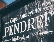 A painted sign for Capel Annibyniol Pendref.
