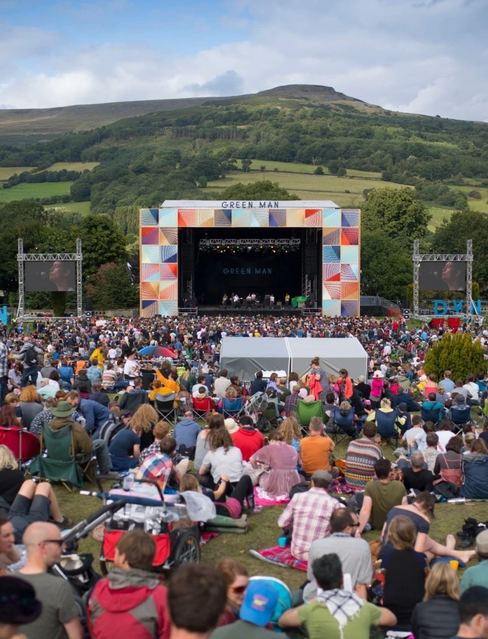 A stage at a festival in a field.