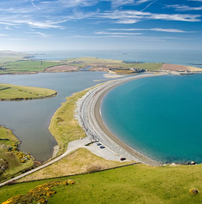 Aerial view of Cemlyn Bay, Isle of Anglesey on bright calm day.