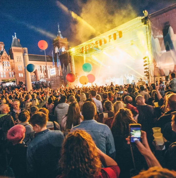 A crowd of people facing a stage