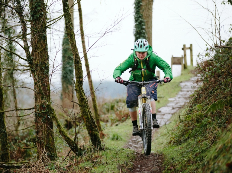 A mountain biker heading down a trail.