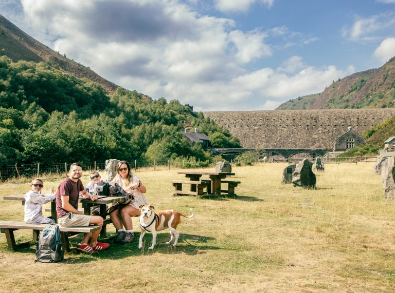 people sat on benches in Elan Valley.