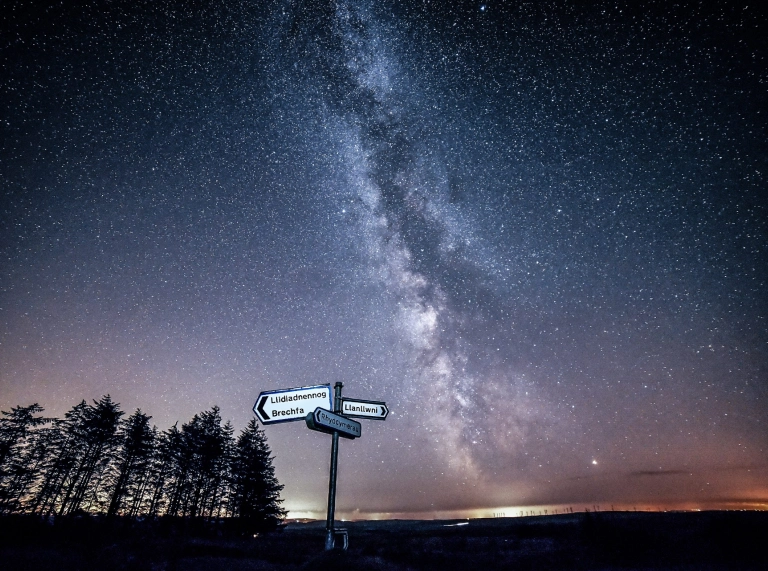 Mid Wales road sign against a backdrop of beautiful stars.
