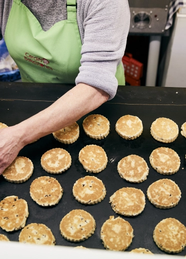 Woman cooking Welsh cakes.