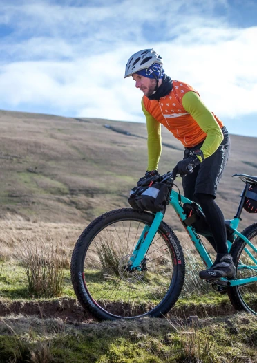 A man on a mountain bike on a hillside.