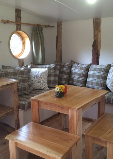interior of hobbit home, with seating and table.