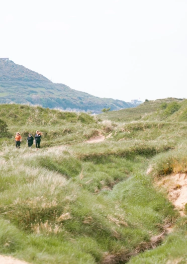 three women walking in nature reserve.