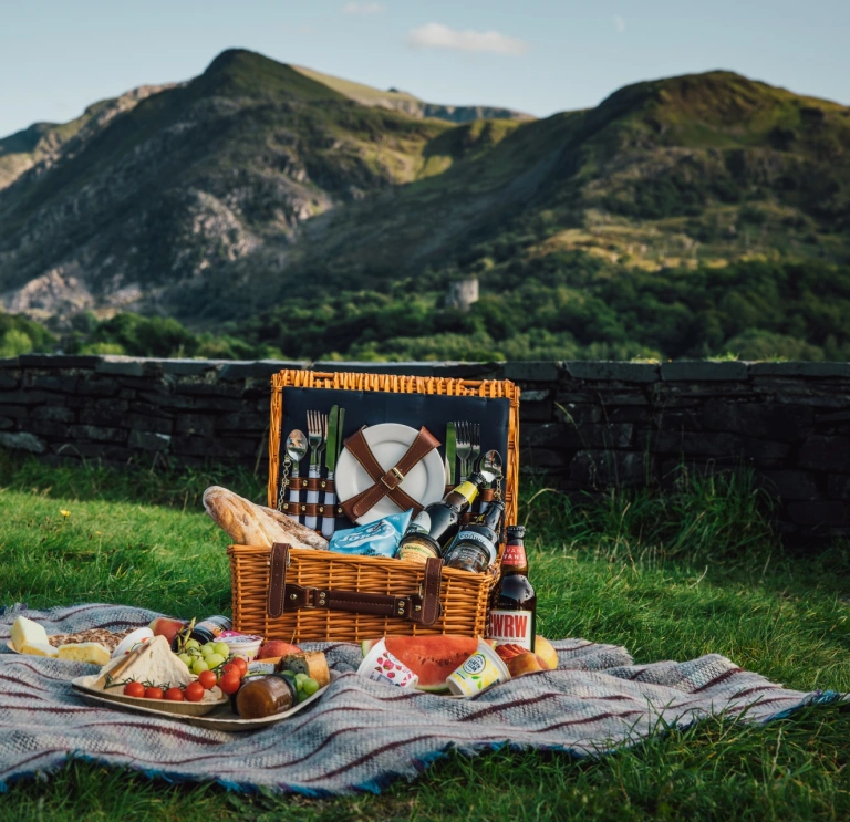 picnic with Welsh products and mountains in background.