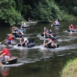 A group of people racing in coracles in West Wales.