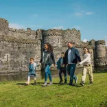 family walking near castle.