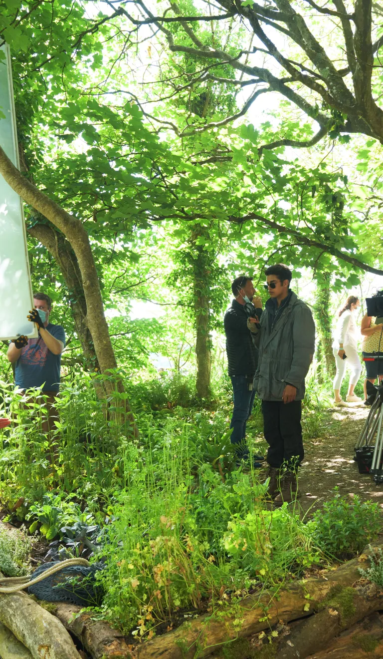 Film crew filming in woodland